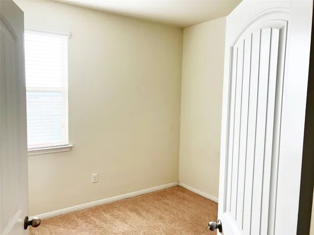 a view of an empty room with closet