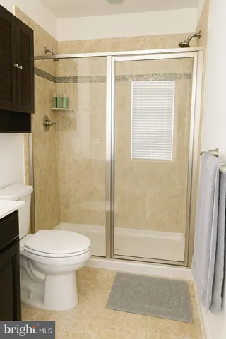 a bathroom with a sink a toilet and a shower