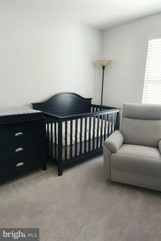 a living room with couches and painting on the wall