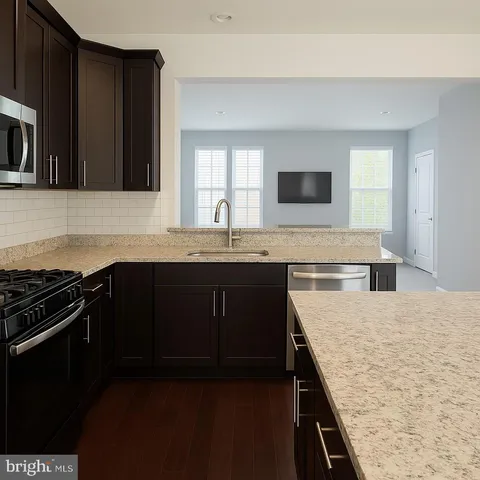 a kitchen with a sink stove and microwave