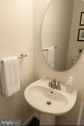 a bathroom with a sink vanity and a mirror
