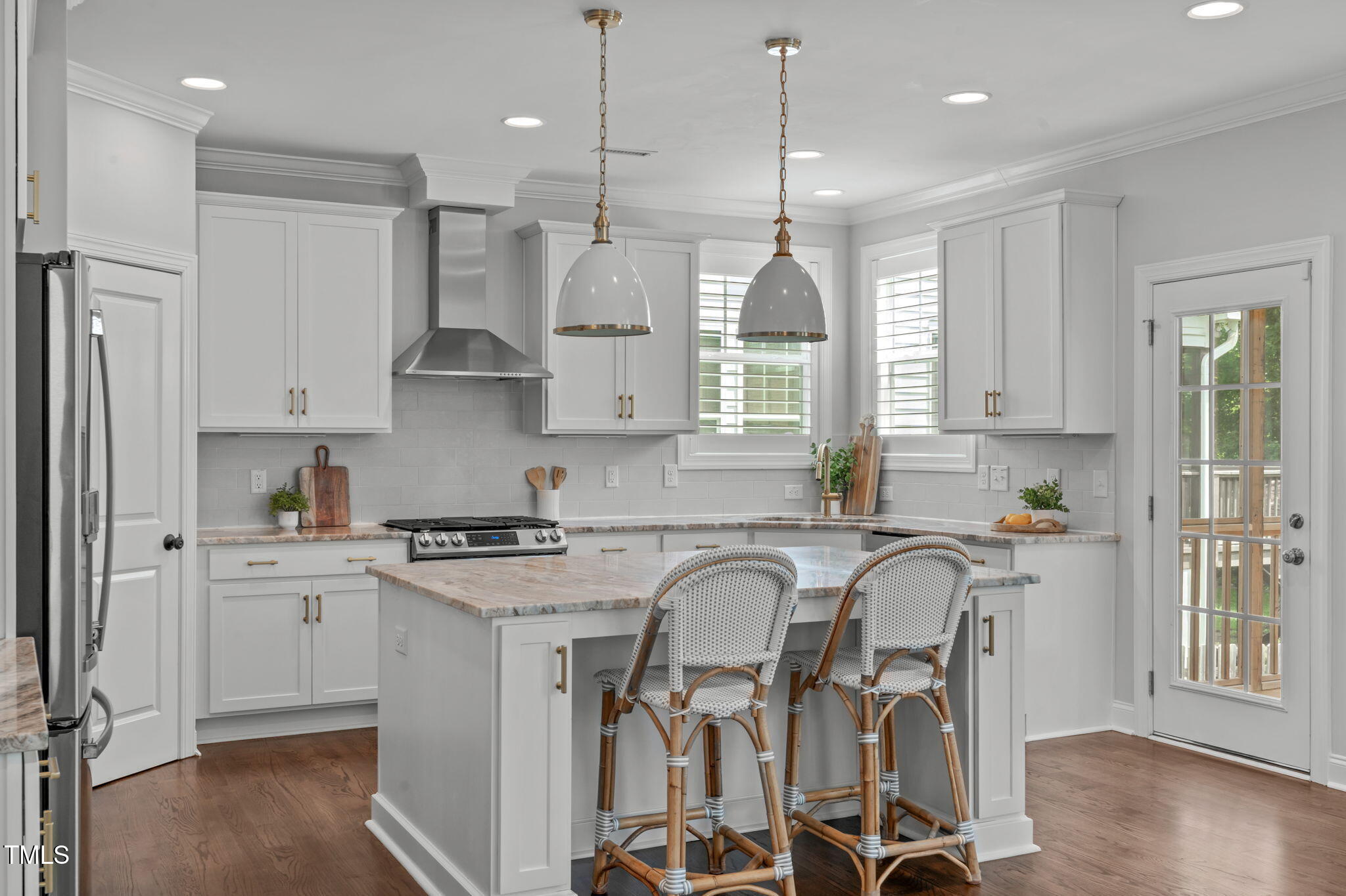 409 Morreene Road Durham, NC 27705 - Photo 11 of 30 a kitchen with stainless steel appliances granite countertop a stove a sink refrigerator and white cabinets with wooden floor