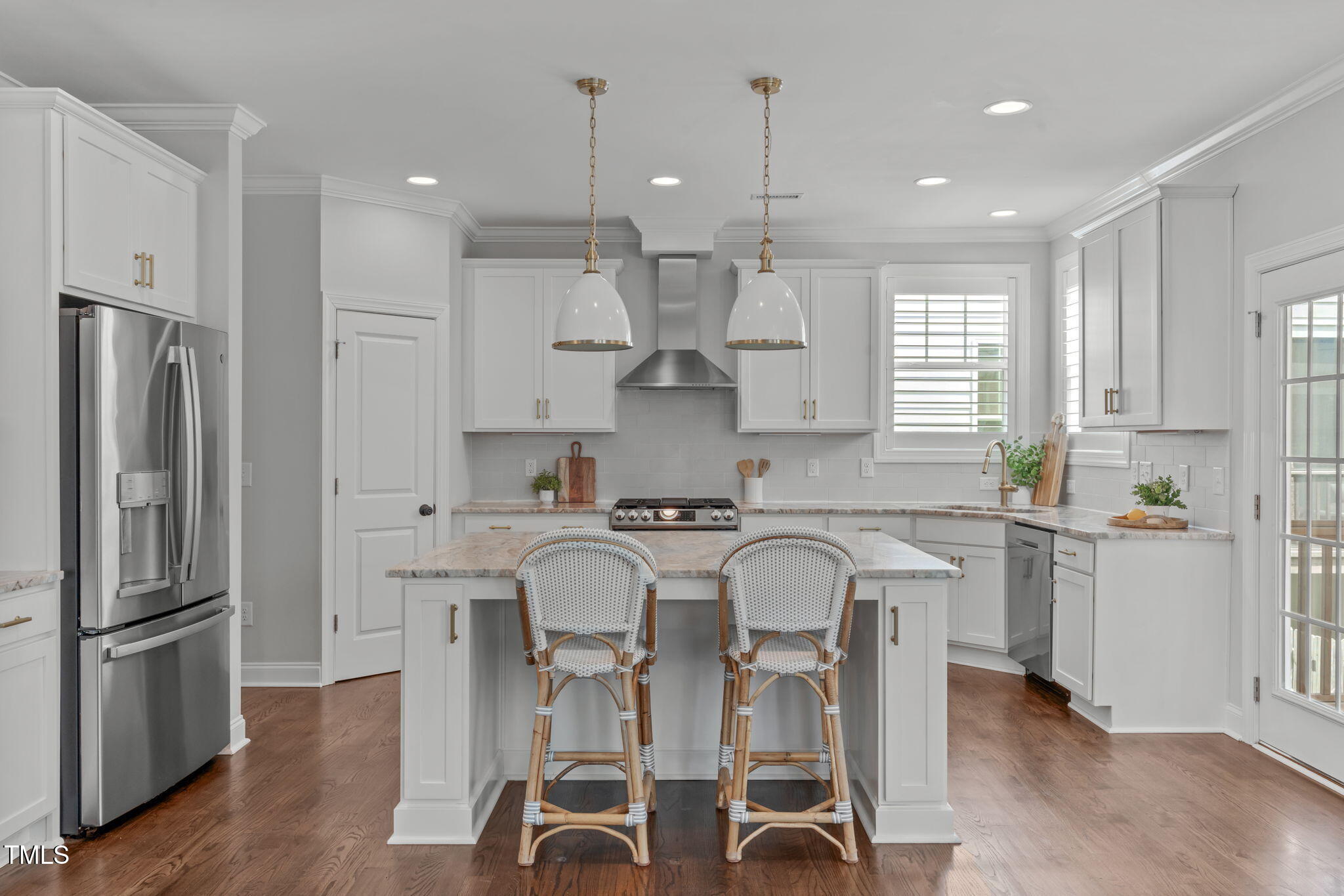 409 Morreene Road Durham, NC 27705 - Photo 12 of 30 a kitchen with stainless steel appliances a table a stove a refrigerator cabinets and chairs