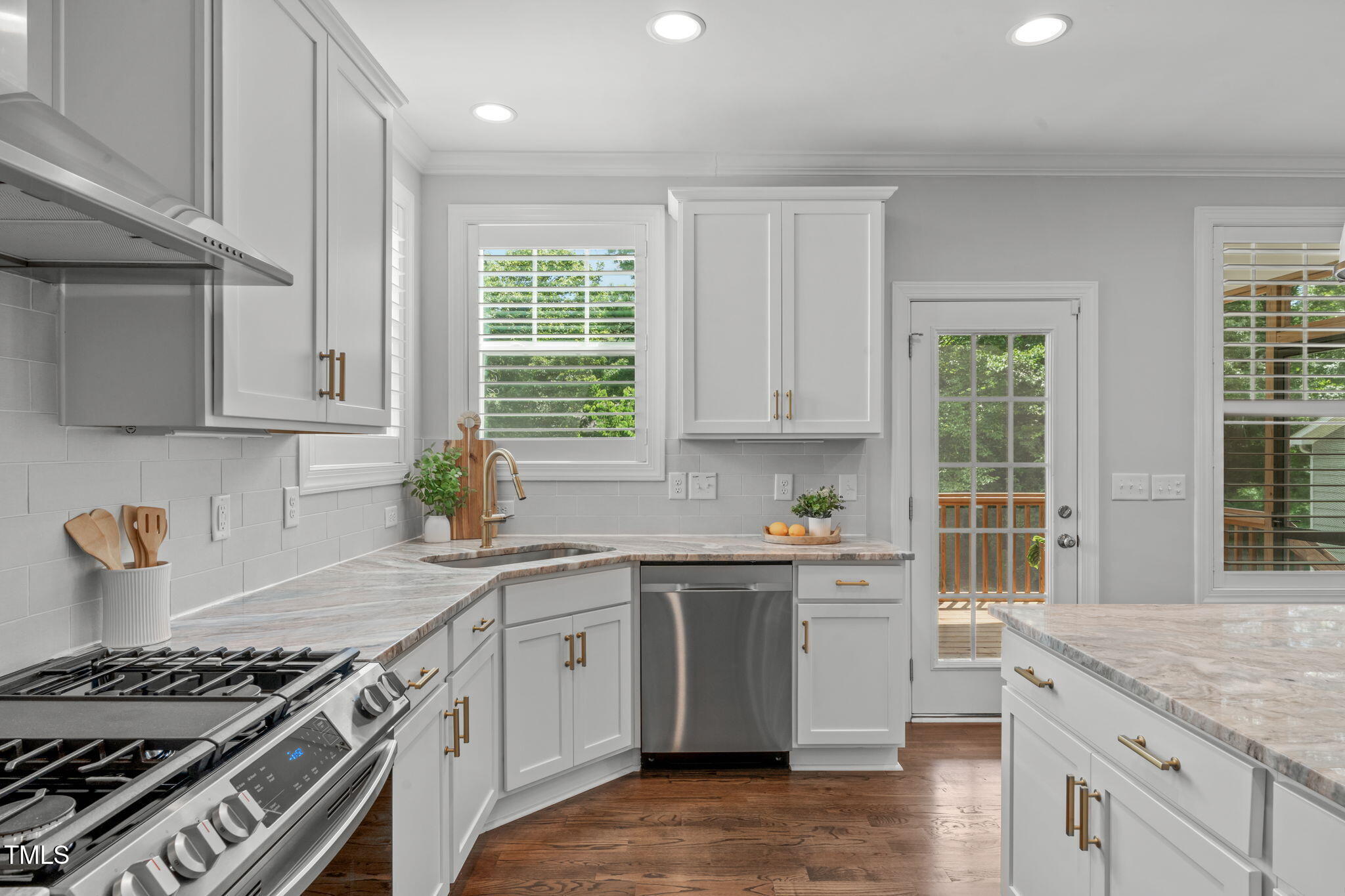409 Morreene Road Durham, NC 27705 - Photo 13 of 30 a kitchen with stainless steel appliances granite countertop a sink stove and cabinets