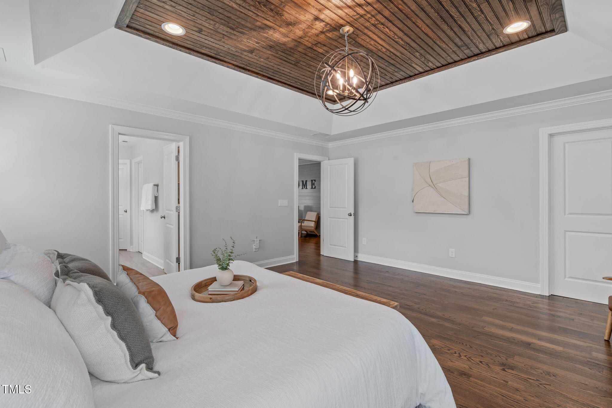 409 Morreene Road Durham, NC 27705 - Photo 17 of 30 a bedroom with a bed and a chandelier