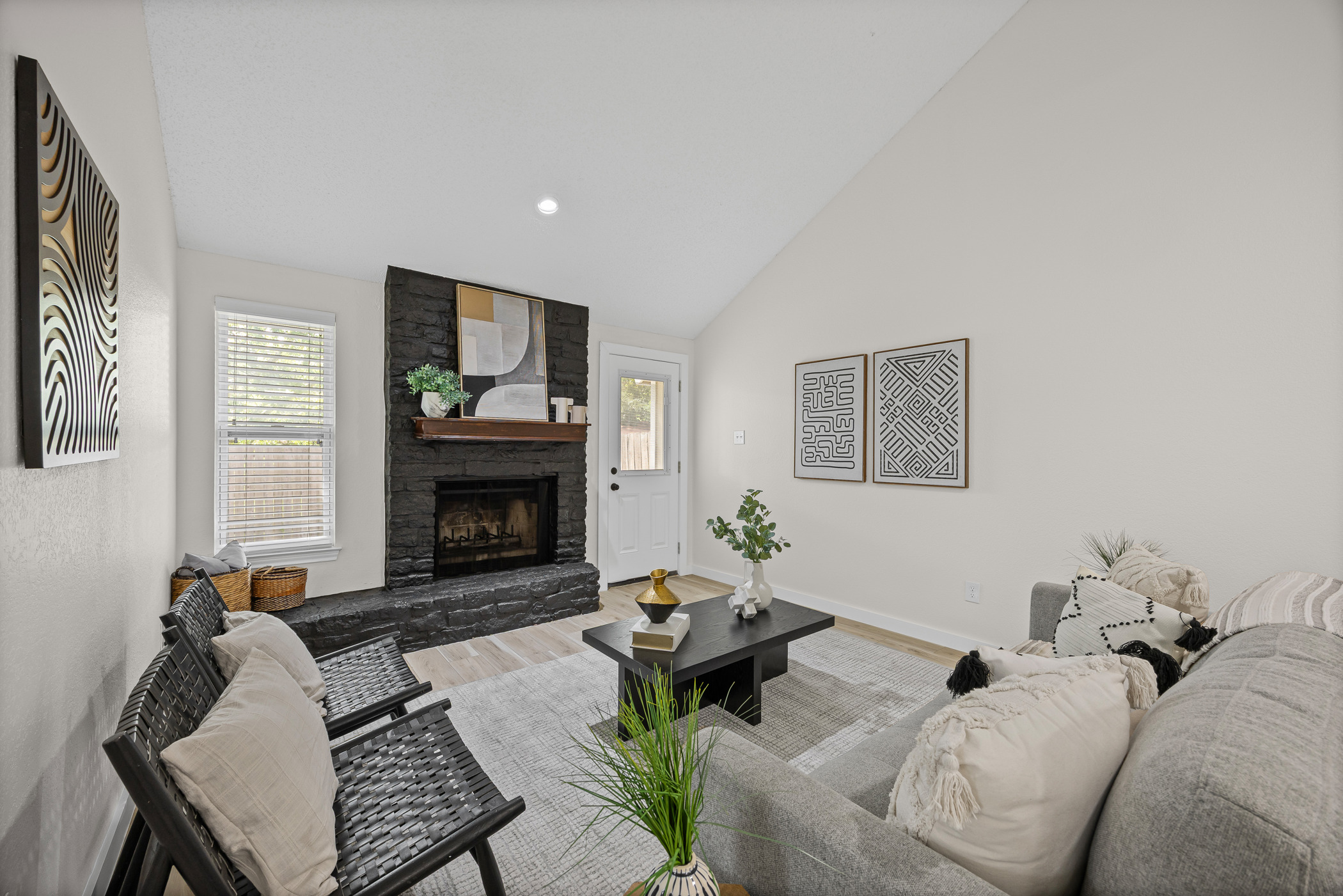 Living area featuring light wood-style flooring, high vaulted ceiling, a  fireplace, and recessed lighting