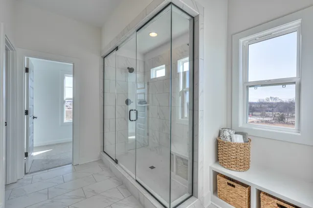 a view of an entryway with a cabinet and mirror
