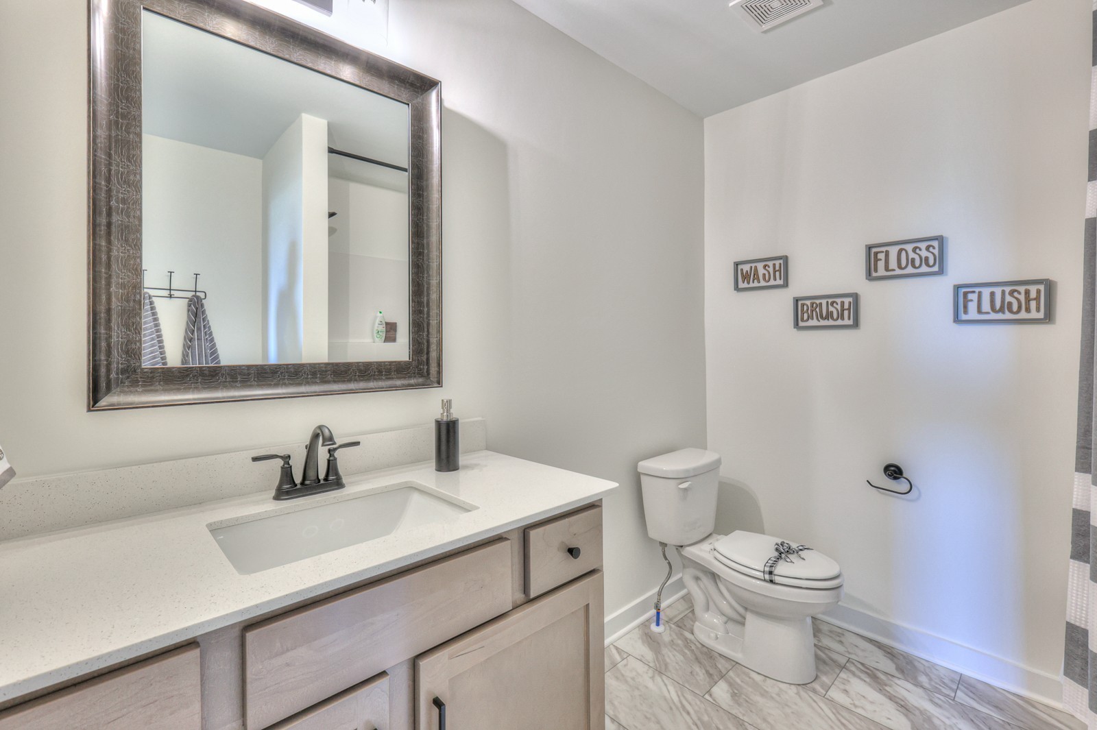 2846 Bluestem Road Columbia, TN 38401 - Photo 23 of 28 a bathroom with a sink toilet a mirror and shower