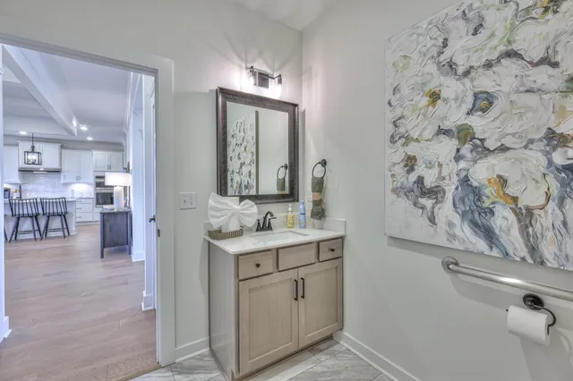 a bathroom with a granite countertop sink a toilet and a mirror