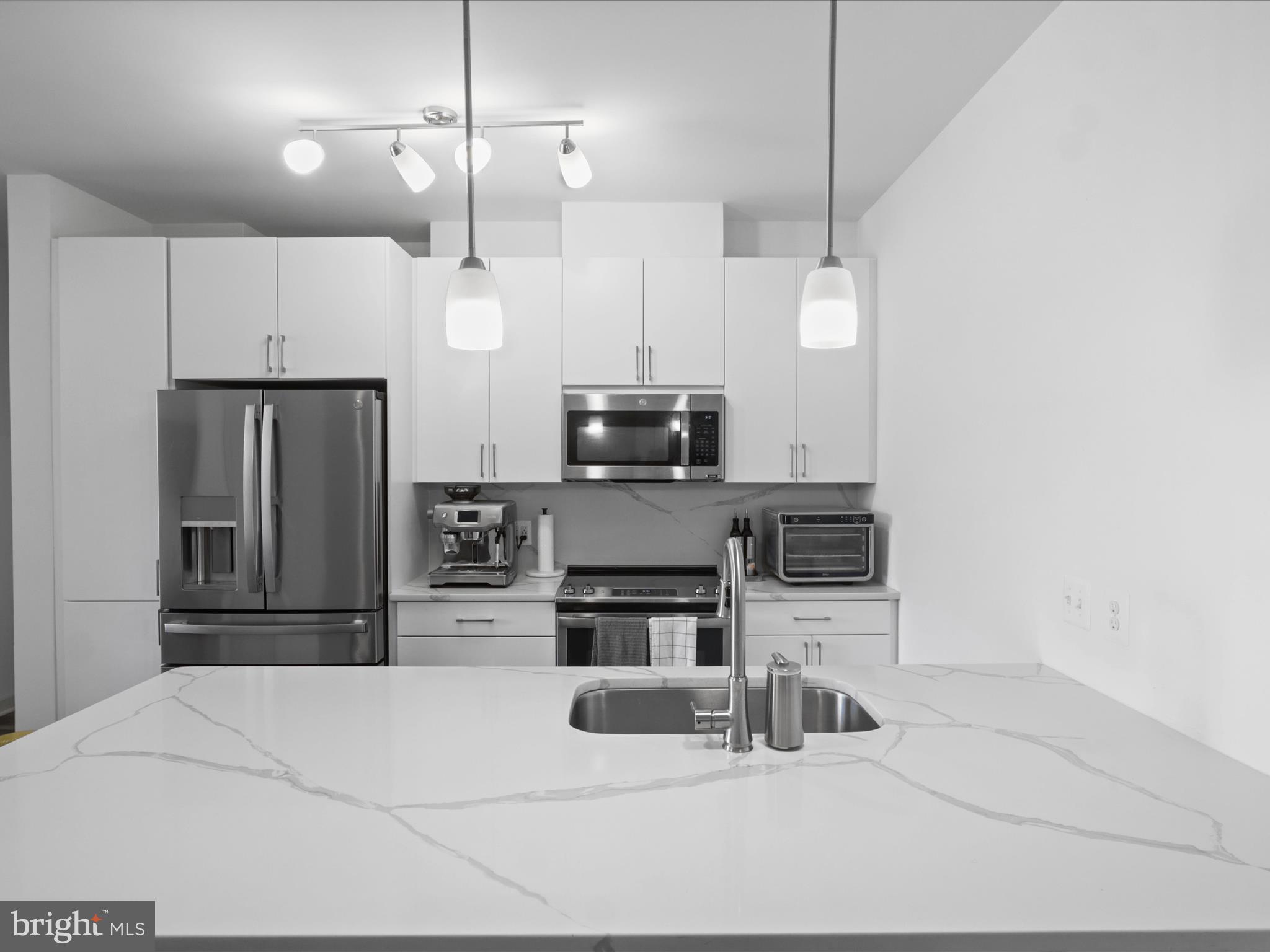 10755 Fairgrounds Drive, Unit 223 Fairfax, VA 22030 - Photo 12 of 28 a kitchen with kitchen island a counter top stainless steel appliances and cabinets
