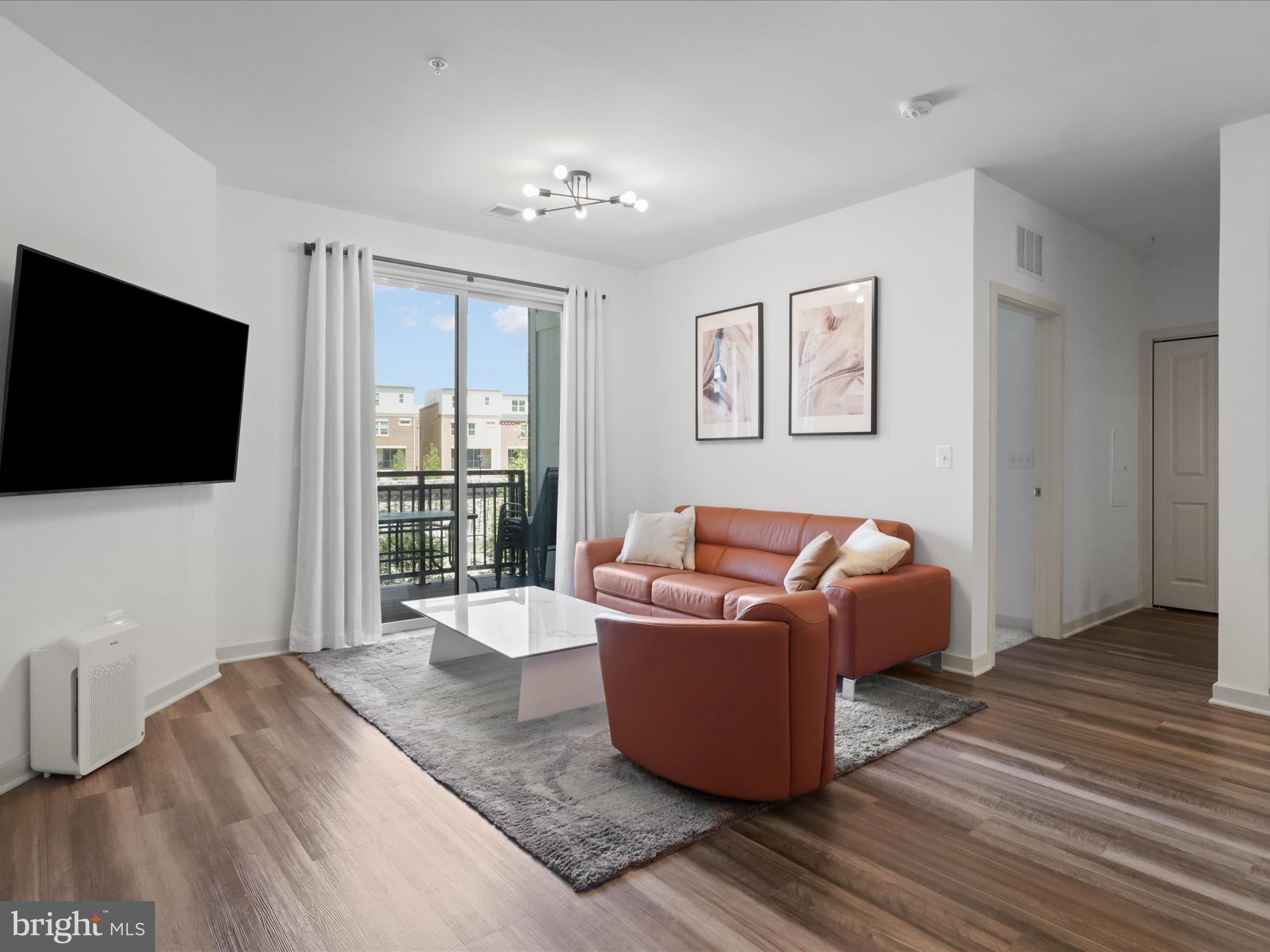 10755 Fairgrounds Drive, Unit 223 Fairfax, VA 22030 - Photo 13 of 28 a living room with furniture and a flat screen tv