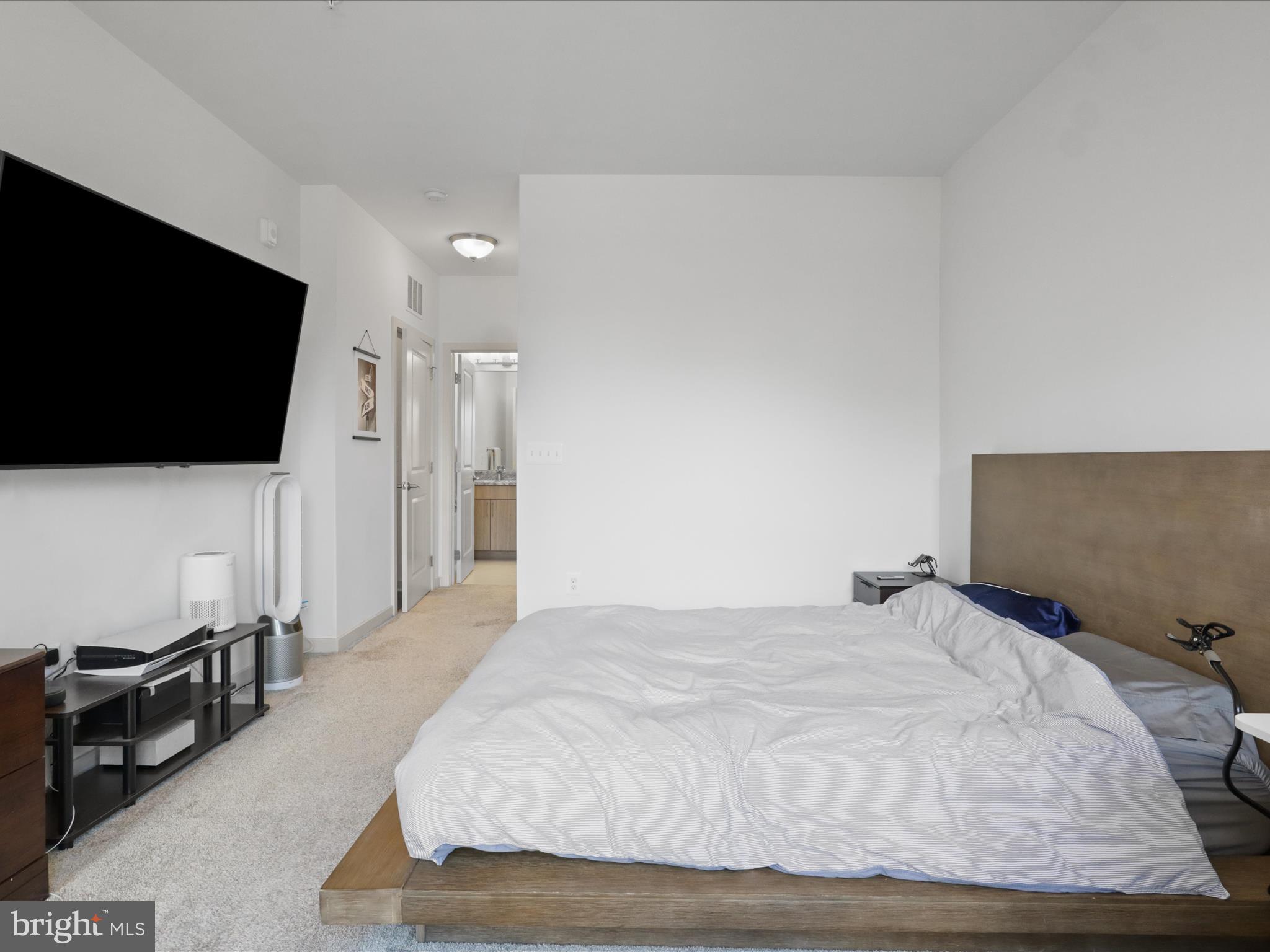 10755 Fairgrounds Drive, Unit 223 Fairfax, VA 22030 - Photo 17 of 28 a bedroom with a bed and a flat screen tv