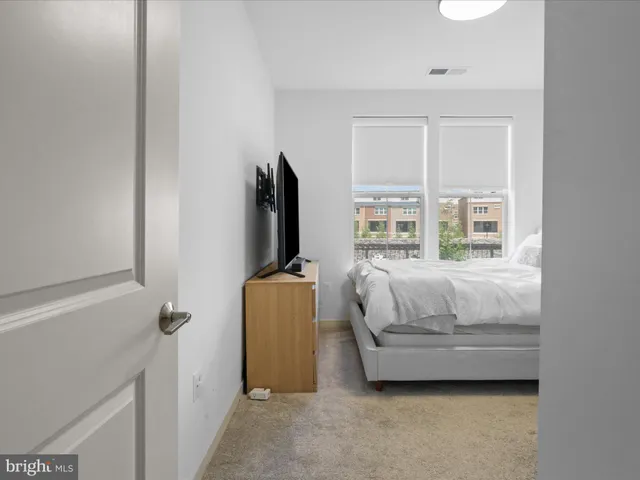 a bedroom with a bed and a flat screen tv