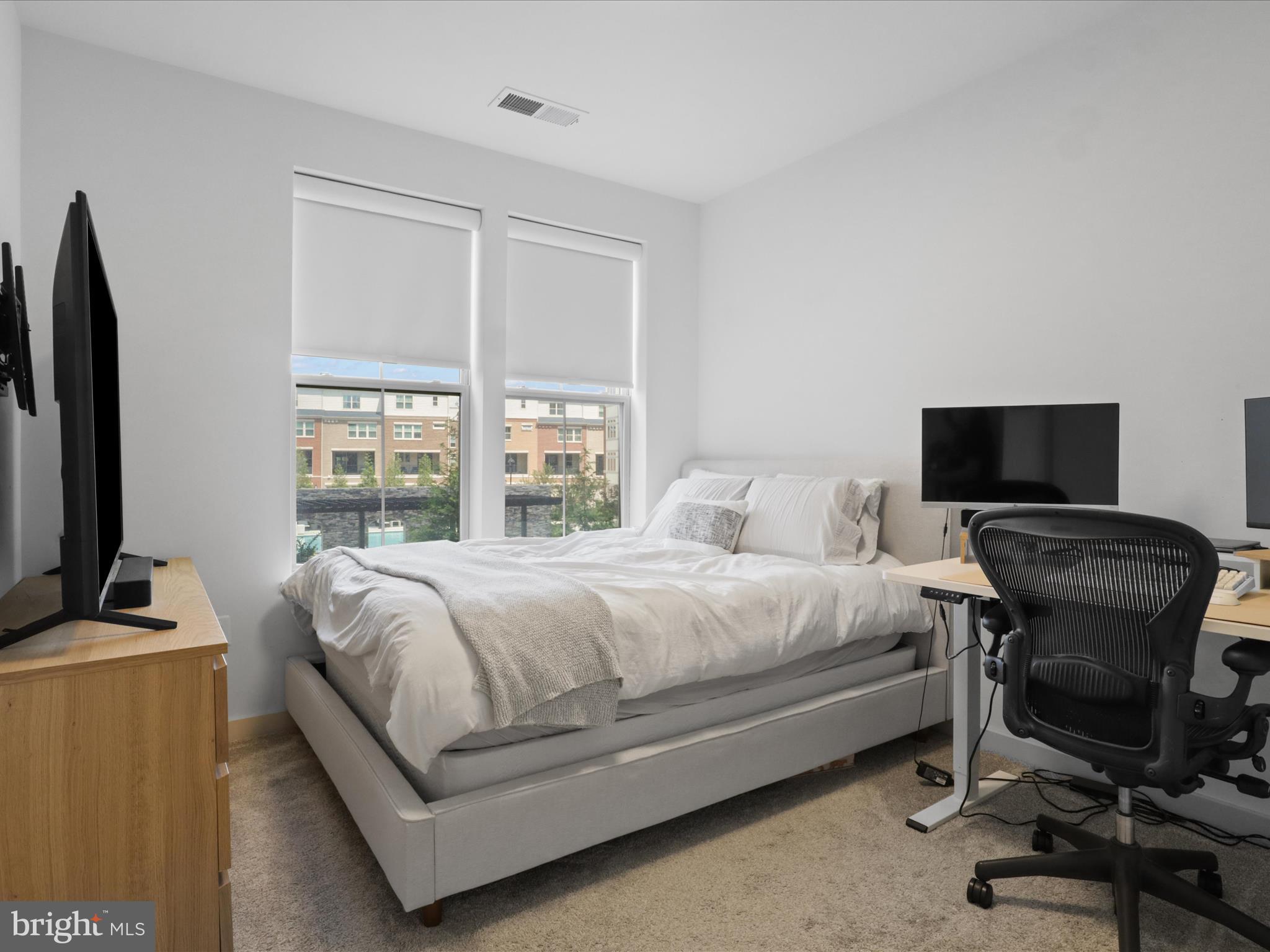 10755 Fairgrounds Drive, Unit 223 Fairfax, VA 22030 - Photo 21 of 28 a bedroom with a bed and a flat screen tv