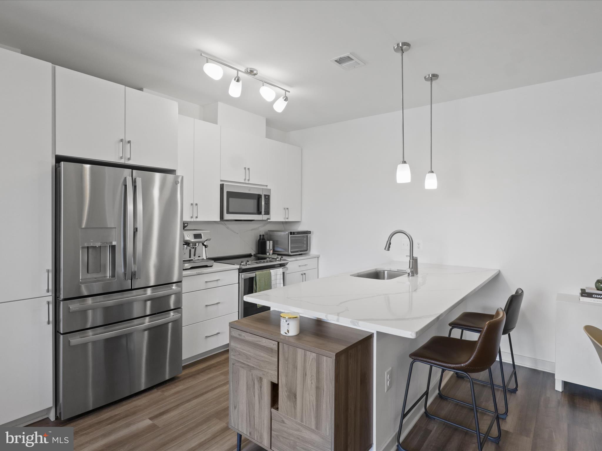 10755 Fairgrounds Drive, Unit 223 Fairfax, VA 22030 - Photo 10 of 28 a kitchen with stainless steel appliances granite countertop a kitchen island hardwood floor and a sink