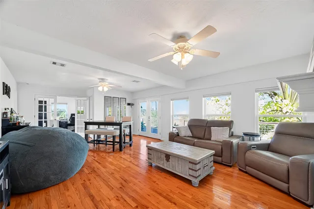 a living room with furniture and a wooden floor
