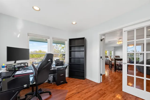 a view of a workspace with furniture and wooden floor