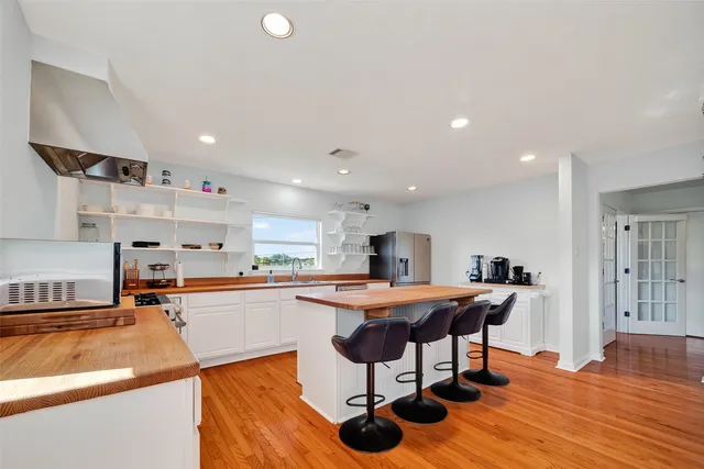 a kitchen with stainless steel appliances kitchen island granite countertop a sink and cabinets