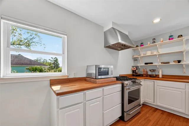 a kitchen with stainless steel appliances a white stove top oven sink and cabinets