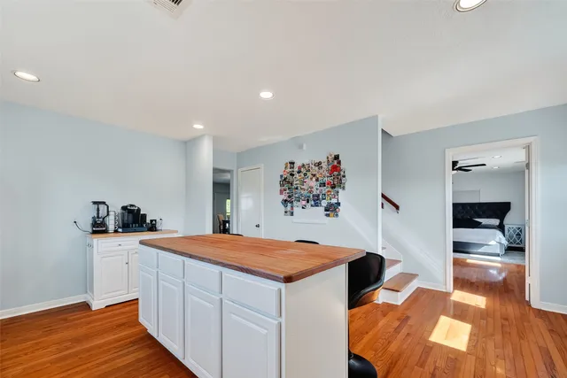 a room with a bed and a kitchen view