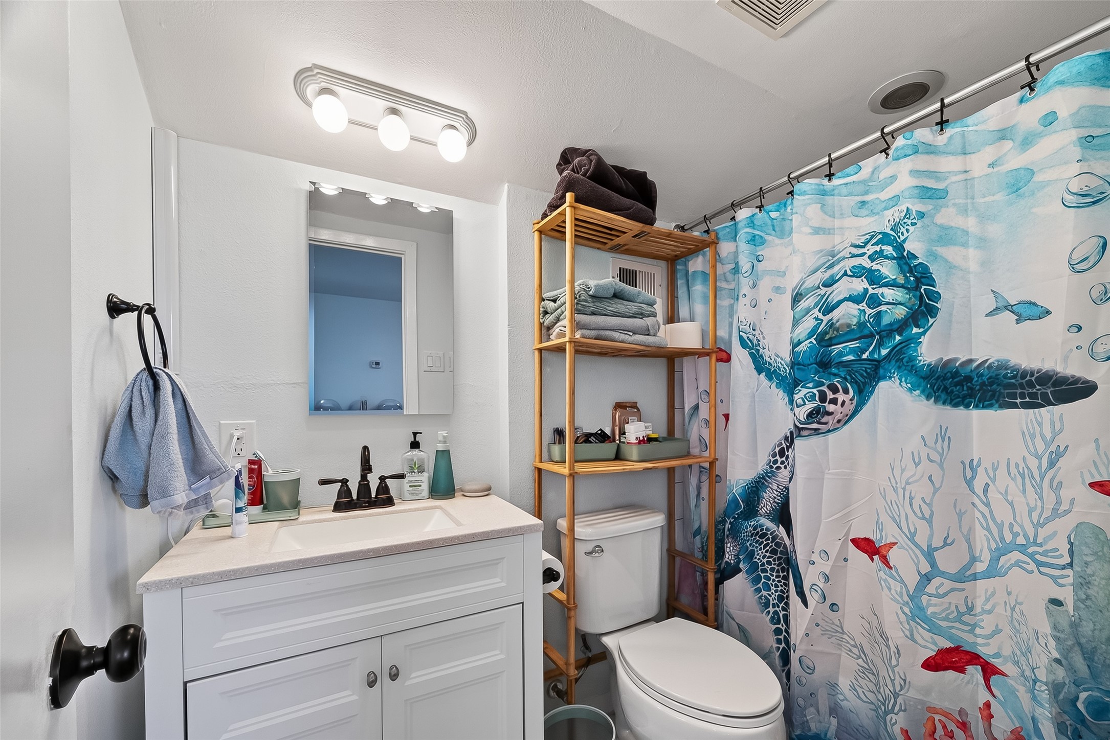 180 Grove Road Kemah, TX 77565 - Photo 26 of 50 a bathroom with a sink vanity mirror and toilet