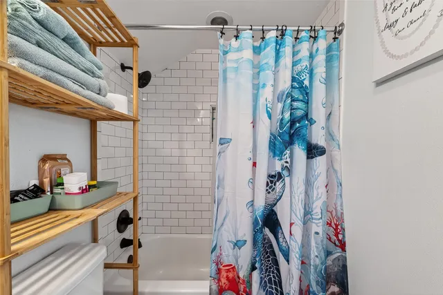 a bathroom with a bathtub and shower