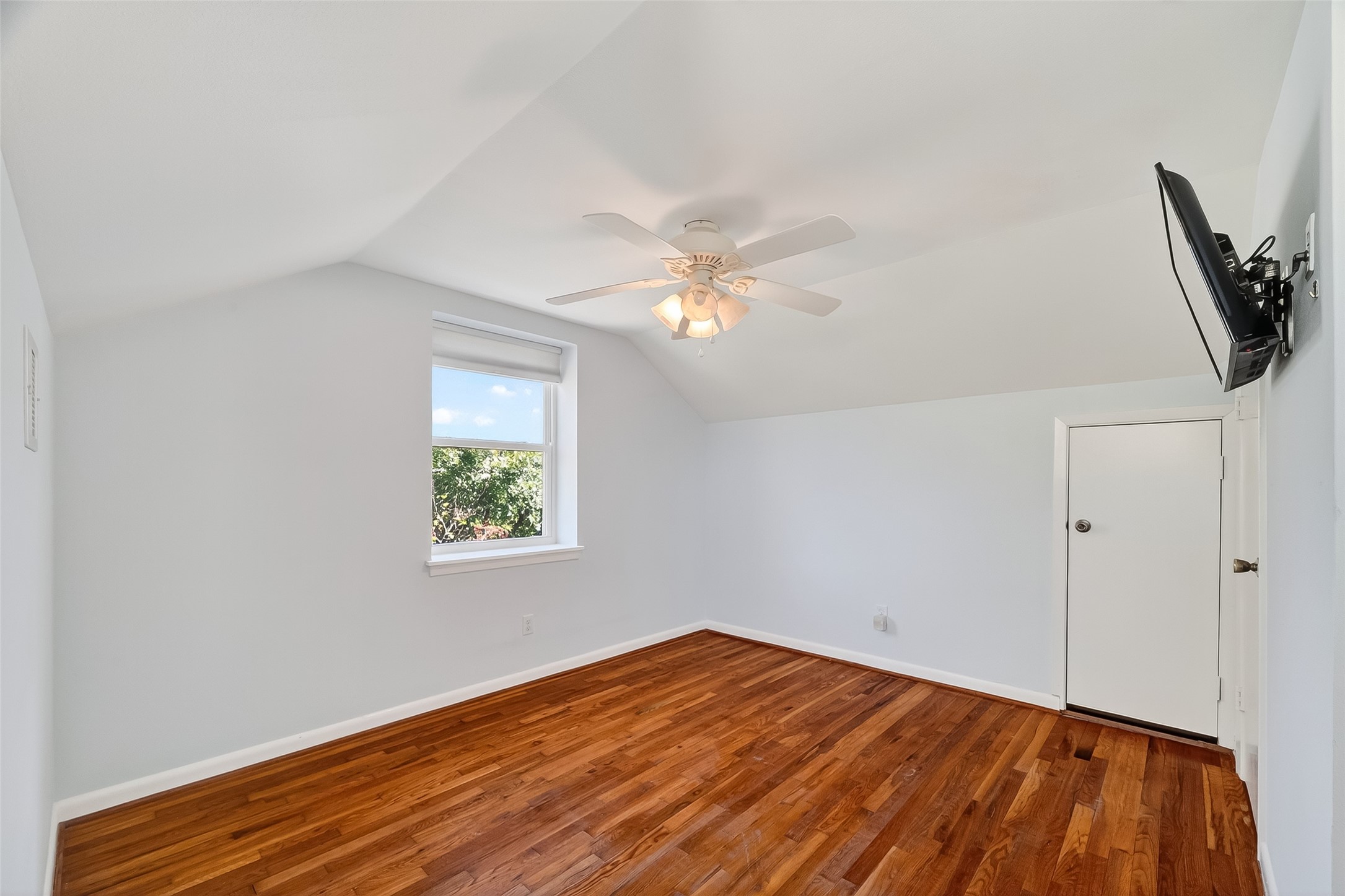 180 Grove Road Kemah, TX 77565 - Photo 28 of 50 an empty room with wooden floor fan and windows