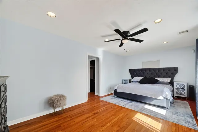 a bedroom with a bed and a ceiling fan