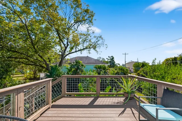a view of a wooden deck next to a yard