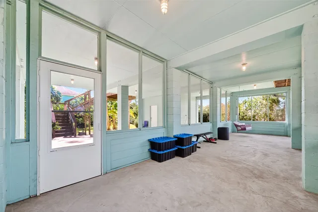 a living room with furniture and large windows