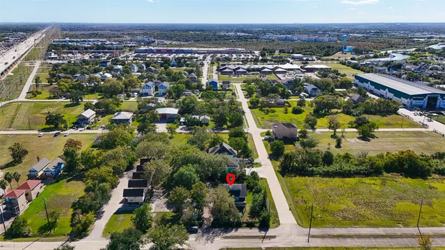 an aerial view of residential houses with outdoor space and swimming pool