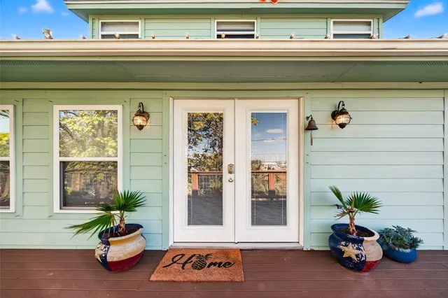 a front view of a house with a potted plant