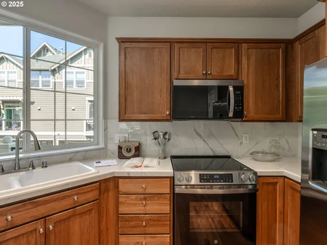 a kitchen with a sink a stove a microwave and cabinets