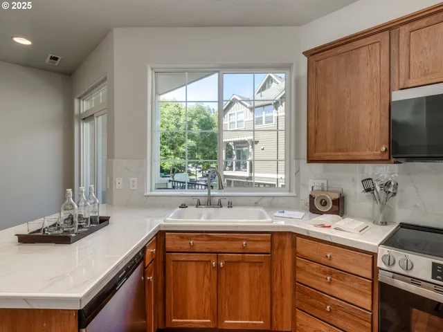 a kitchen with a sink a window and cabinets