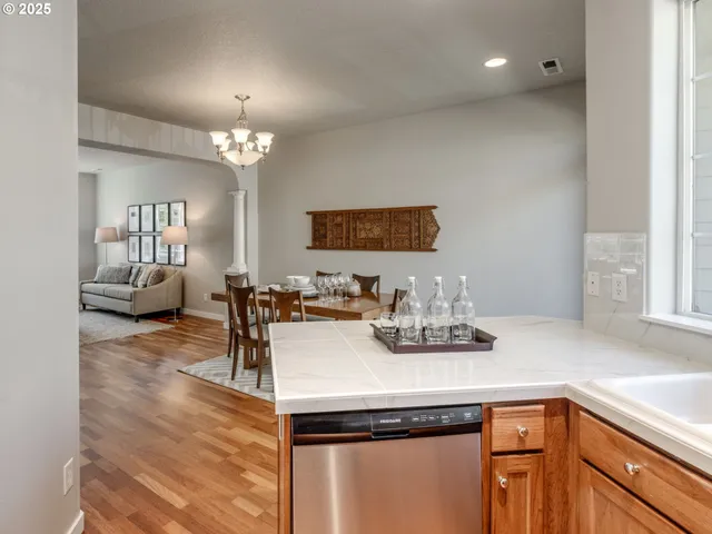a kitchen with kitchen island granite countertop a sink appliances and cabinets