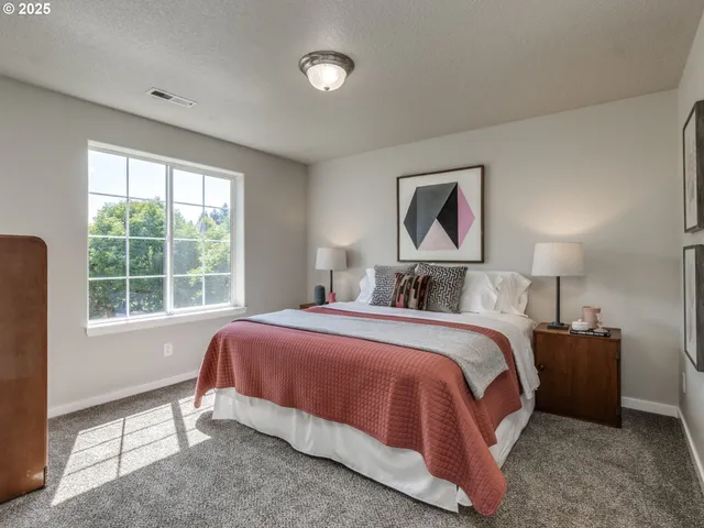 a bedroom with a bed and a lamp