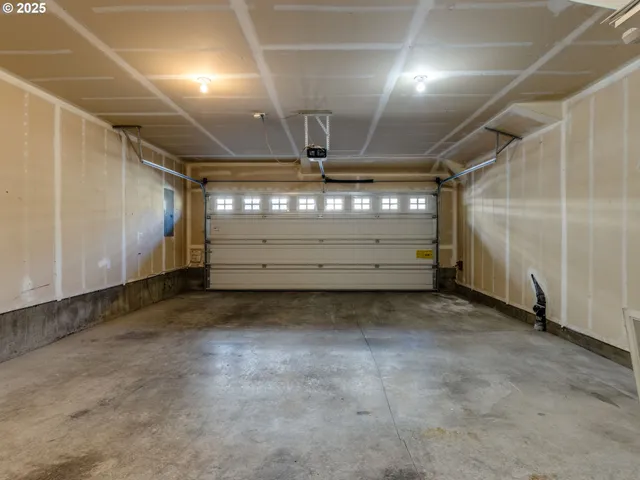 an aerial view of a house with a yard and large tree