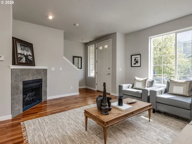 a living room with furniture a rug and a fireplace