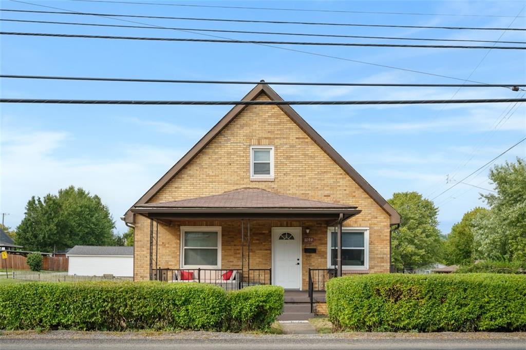 a view of a house with large windows and plants