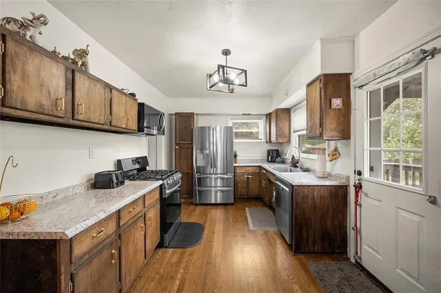 a kitchen with a sink appliances and cabinets