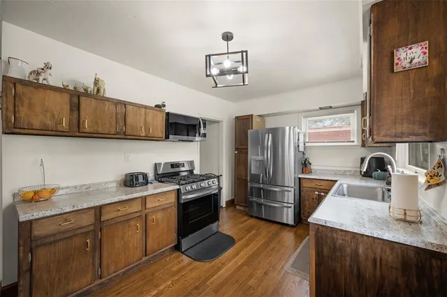 a kitchen with a stove a sink and a window
