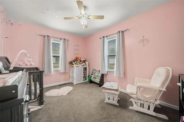 a view of a hallway to a room and a kitchen