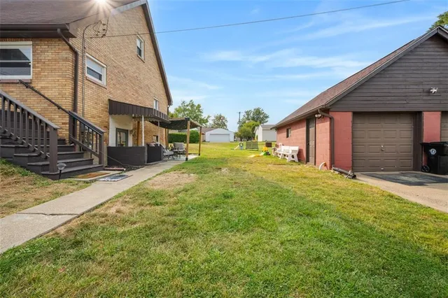 a backyard of a house with table and chairs