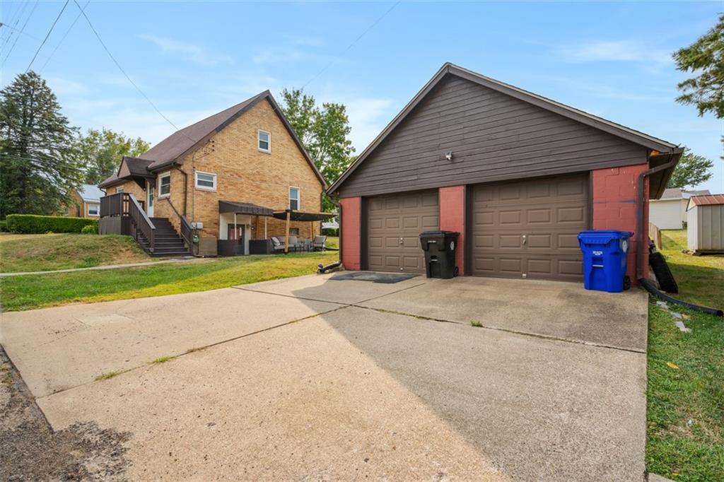 1199 Marshall Road Monaca, PA 15061 - Photo 41 of 46 a front view of a house with a yard and garage