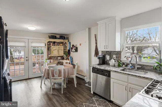 a very nice looking dining room with kitchen island wooden floor and furniture