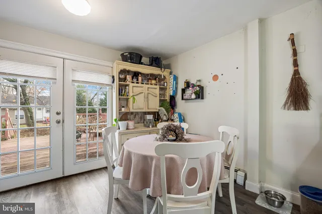 a dining room with furniture and wooden floor