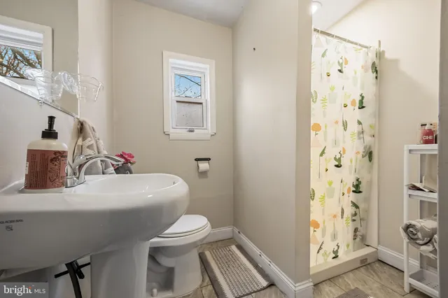 a white toilet sitting next to a bathroom sink