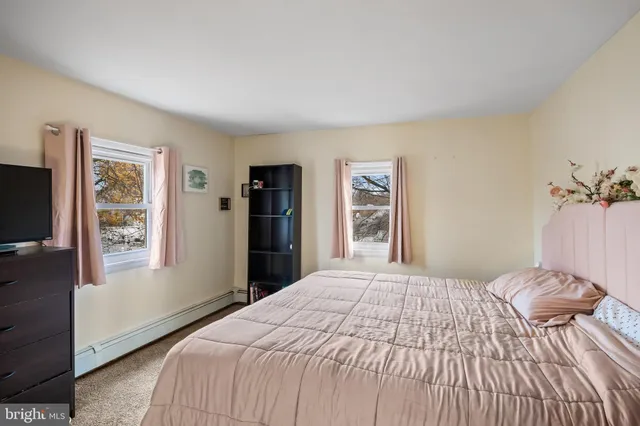 a bedroom with a large bed and a window