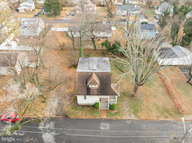a view of a tree with back yard of the house