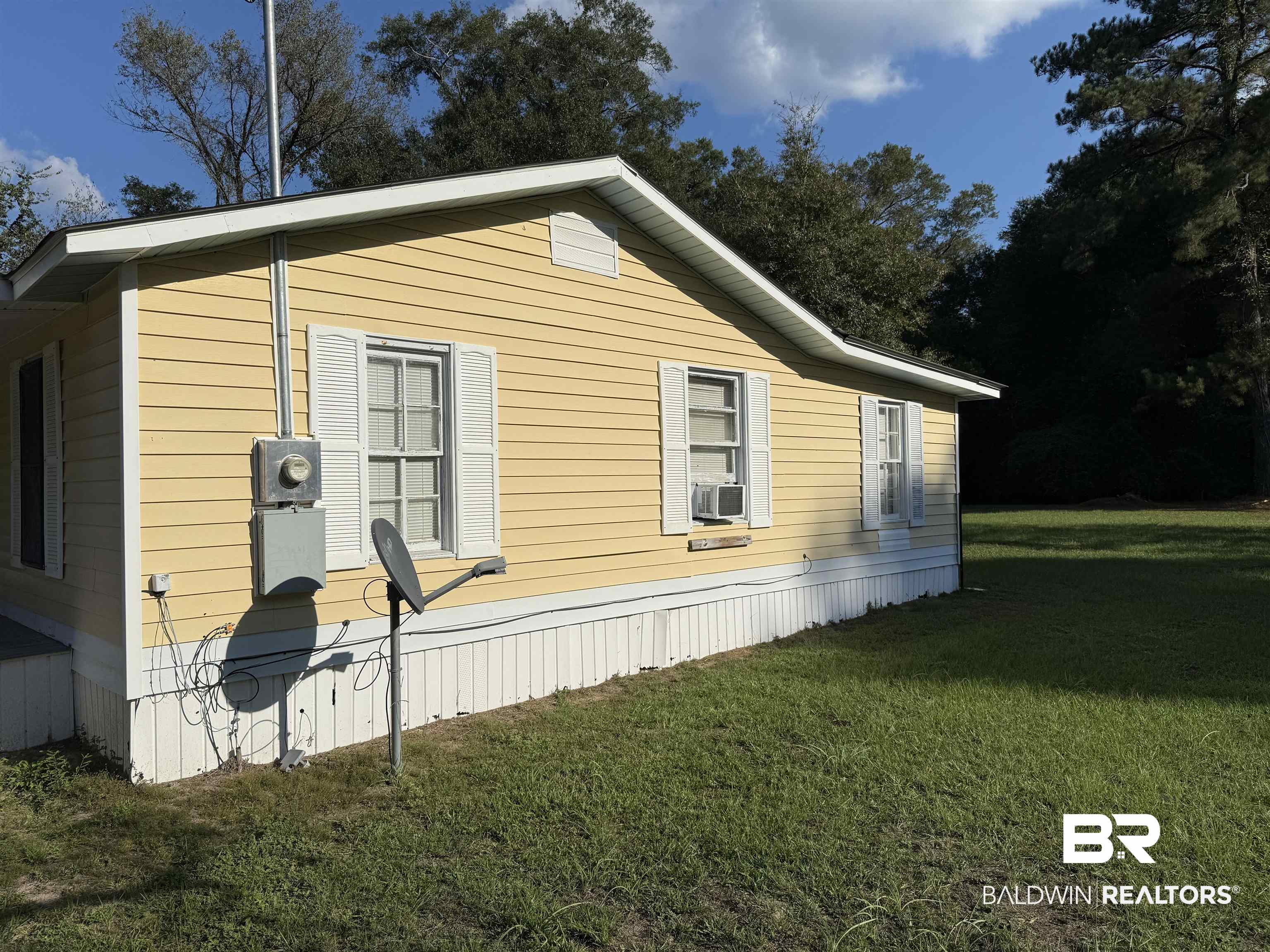 3630 Highway 29 Brewton, AL 36426 - Photo 5 of 13 View of home's exterior with a lawn and cooling unit